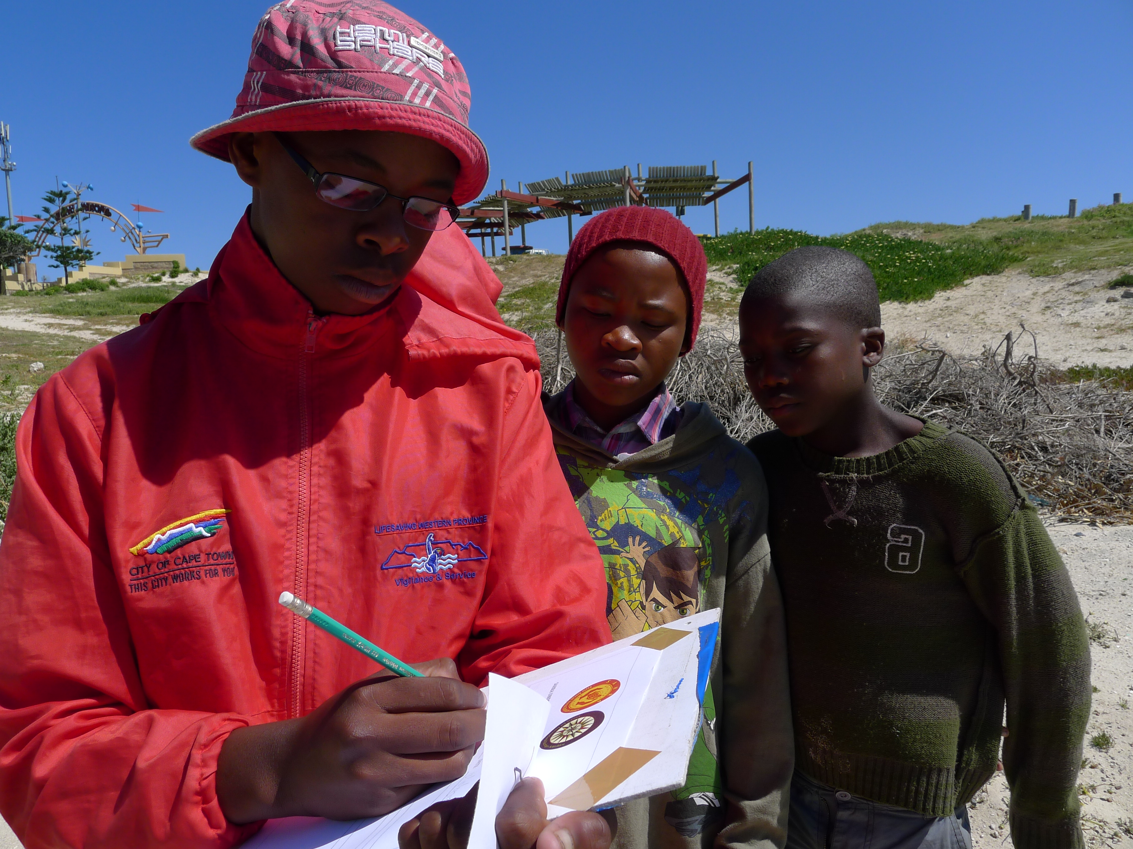 Young members of a Cape Town youth network recording information during an outdoor heritage activity