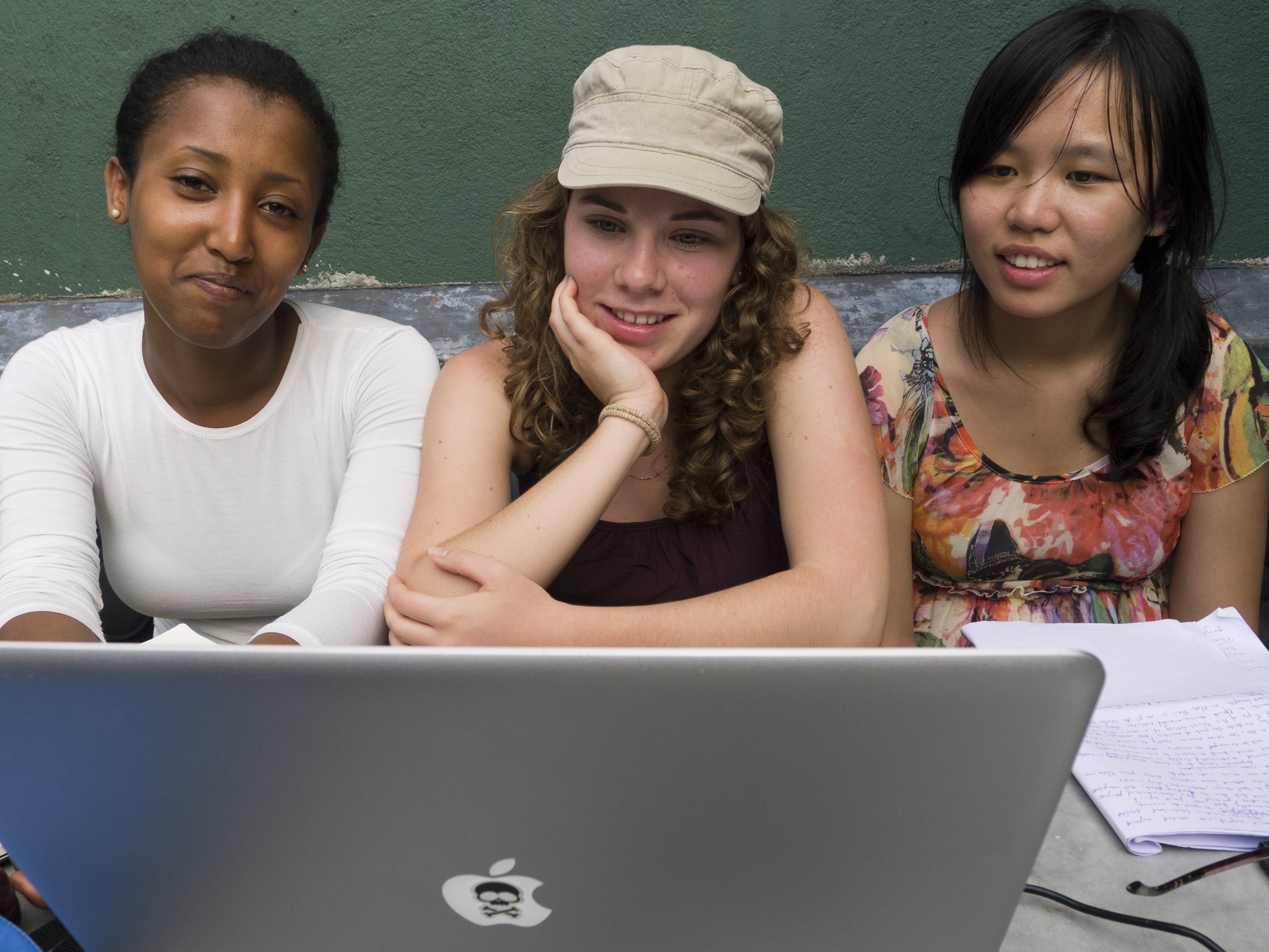 Three World Heritage Field School participants working together at a laptop